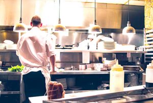 Chef in stainless steel restaurant kitchen. Did the kitchen installer provide the chef with a warranty for the benches. Did it have terms and conditions
